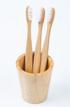 Bamboo toothbrush in wooden glass.