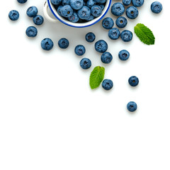 Blueberry in ceramic bowl isolated on white. Fresh blueberry closeup, healthy diet concept. Ripe organic bilberry, mint leaf creative composition. Juicy berries background, top view.