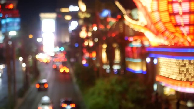 Defocused fabulous Las Vegas Strip boulevard, luxury casino and hotel, gambling area in Nevada, USA. Nightlife and traffic near Fremont street in tourist money playing resort. Neon lights of sin city.