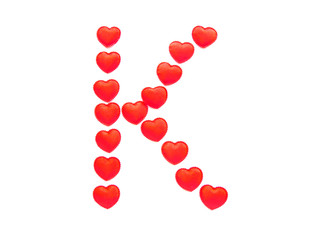 The letter K is made up of small red hearts isolated on a white background. Bright red font.