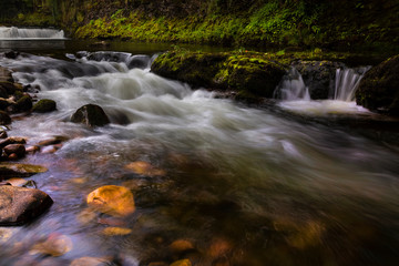 A section of fast flowing water on the river Tawe as it passes Abercrave in the Swansea Valley, South Wales UK
