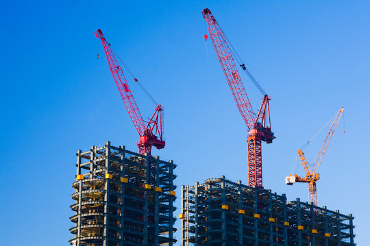 building construction site and cranes with the blue sky background