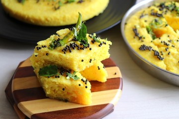 Indian traditional Dal dhokla. Khaman dhokla is a famous dish of Gujarat. Made using rice, healthy mix lentils and pulses, along with spices. garnished with coriander & fried chilies. Copy space.