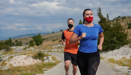 couple running in nature wearing mask