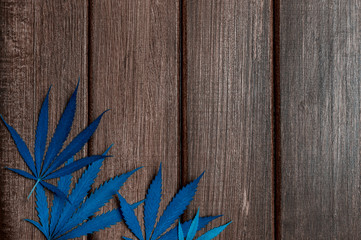 Hemp or cannabis leaf isolated on wooden background. Alternative medicine. Vegetarian food concept....