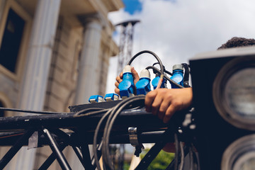 lighting technician iinstalling professional lighting equipment for concert stage , installation with led lights and projectors