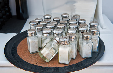 Several salt shakers on the dish in kitchen
