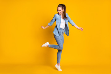 Full size photo of pretty candid satisfied girl enjoy rejoice dancing weekend discotheque wear good look outfit gumshoes isolated over vivid color background