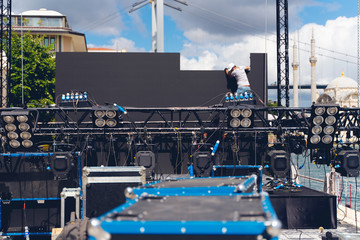 lighting and Led panel technician iinstalling professional lighting equipment for concert stage ,...