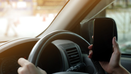 The driver uses the phone while driving. Isolated screen for mockup. Car navigation display in background.