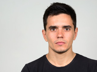 Fototapeta premium Portrait of handsome man against white background