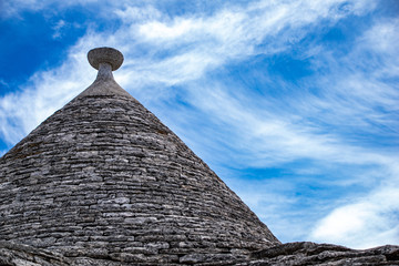Fototapeta na wymiar South of the Italy, alberobello with blue sky in background and the trulli in foreground