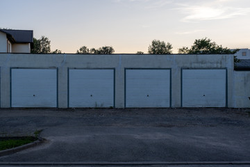 garage row at sunset with white automatic doors