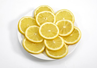 Fototapeta na wymiar Plate with Yellow Lemon, citrus limonum, against White Background