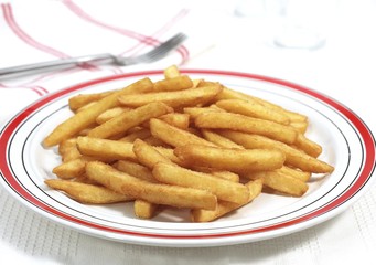 Plate with French Fries against White Background