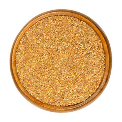 Dried grated lemon peel in a wooden bowl. Dry zests of ripe yellow edible citrus fruits. Citrus limon. Used as flavoring for baking and cooking. Close up, from above, over white, isolated, food photo.