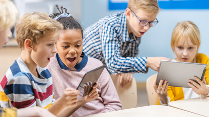 School Computer Science Class: Schoolchildren Use Digital Tablet Computers and Smartphones with...