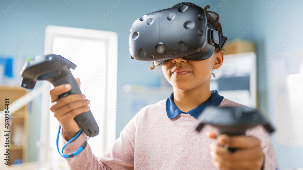 Poster elementary school computer science class: cute girl wearing augmented reality headset and using cont