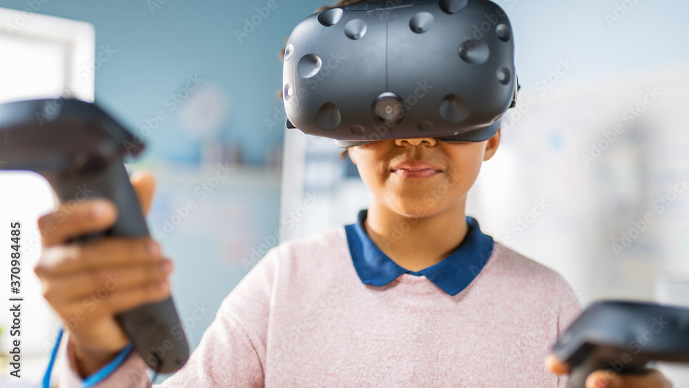 Poster elementary school computer science class: cute girl wearing augmented reality headset and using cont