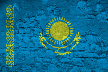 national flag of the state of Kazakhstan on an old stone wall with cracks, the concept of tourism, emigration, economy, politics, global world trade