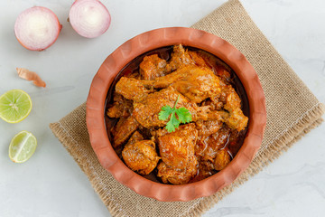 Spicy Indian Chicken Curry with Lemon, Onion and Cilantro, top Down Horizontal Photo