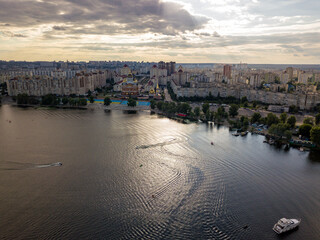 Fototapeta premium Sunset over the river Dnieper in Kiev. Aerial drone view.
