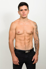 Fototapeta na wymiar Portrait of handsome muscular shirtless man against white background