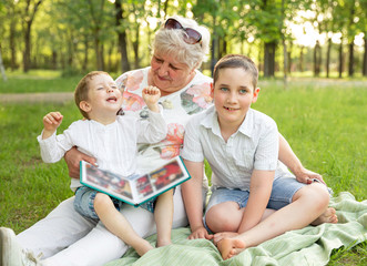 Loving grandmother and grandchildren playing and laughing together