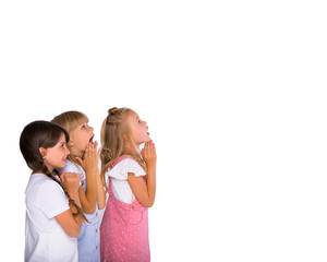 A group of primary school kids girls show emotions of joy and surprise. Isolated on a white background. Studio photo. Copy space for your ad text