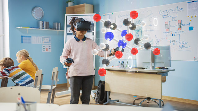 Cute Girl Wearing Augmented Reality Headset and Using Controllers Interacts with 3D Molecule. Futuristic School Science Class for Children Learning in STEM Programs. VFX, Special Effects Render