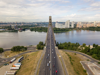 Fototapeta premium Aerial drone view. Cars travel along the North Bridge across the Dnieper in Kiev.