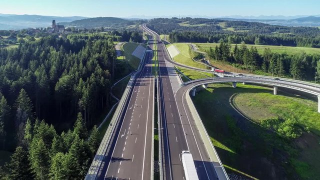 New motorway in Poland on national road no 7, E77, called Zakopianka.  Overpass crossroad with a traffic circle, slip roads and viaducts near Skomielna Biala. Aerial video. Far view of Tatra Mountains