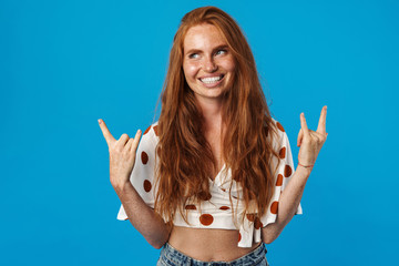 Portrait of a crazy girl showing horns up gesture