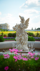 Fototapeta premium Monument is a work of art, cute guardian angels on a background of flowers.