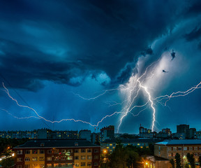 a strong thunderstorm with ligtnings over the city