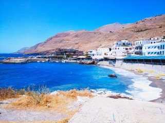 Fototapeta premium Stony port near old town Hora Sfakion and shops at Sfakia in Crete, Greece