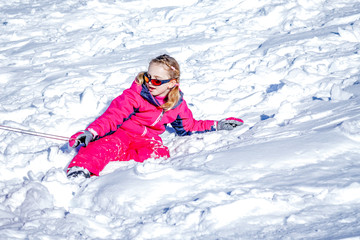Young Girl Sitting On The Snow Mountain and playing with snow ball. Winter time