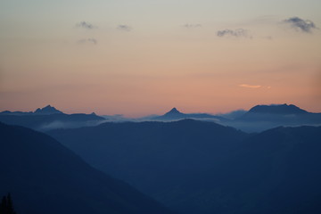 Fototapeta premium beautiful sunset on the mountains with orange sky and view to the alps