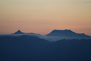 beautiful sunset on the mountains with orange sky and view to the alps
