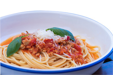 Top view of spagetties bolonaise, Italian dish with basil leaves isolated on white background with clipping path.