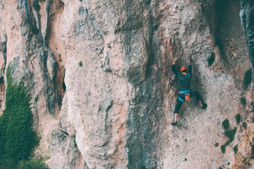 Fototapeta premium A man in helmet climbs the rock.