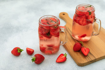 Healthy strawberry drink with berries and wooden board.