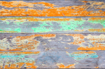 Fototapeta na wymiar Grunge old wooden table with peeling shabby blue and orange paint wood surface textured abstract background. Old vintage retro wooden background.