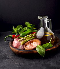 Meat on the black stone with  pepper, basil. pepper, asparagus and olive oil. Meat steak with spices.