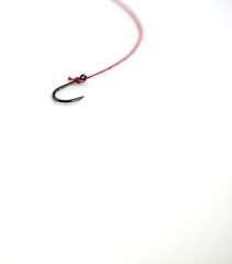 Fishing hook with red rope on white background, with empty space.