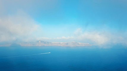 Fototapeta na wymiar The morning mist over the Santorini caldera in Greece