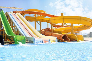 Different colorful slides in water park on sunny day