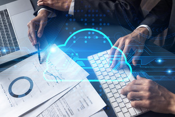 Two business people working together on datum project. Data center concept. Cloud blue hologram. Double exposure.