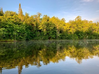 autumn trees reflected in water