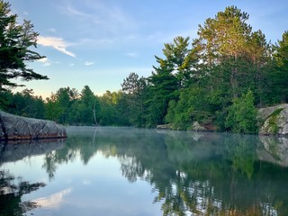 Obraz premium foggy morning on the lake entrance to the river gorge 